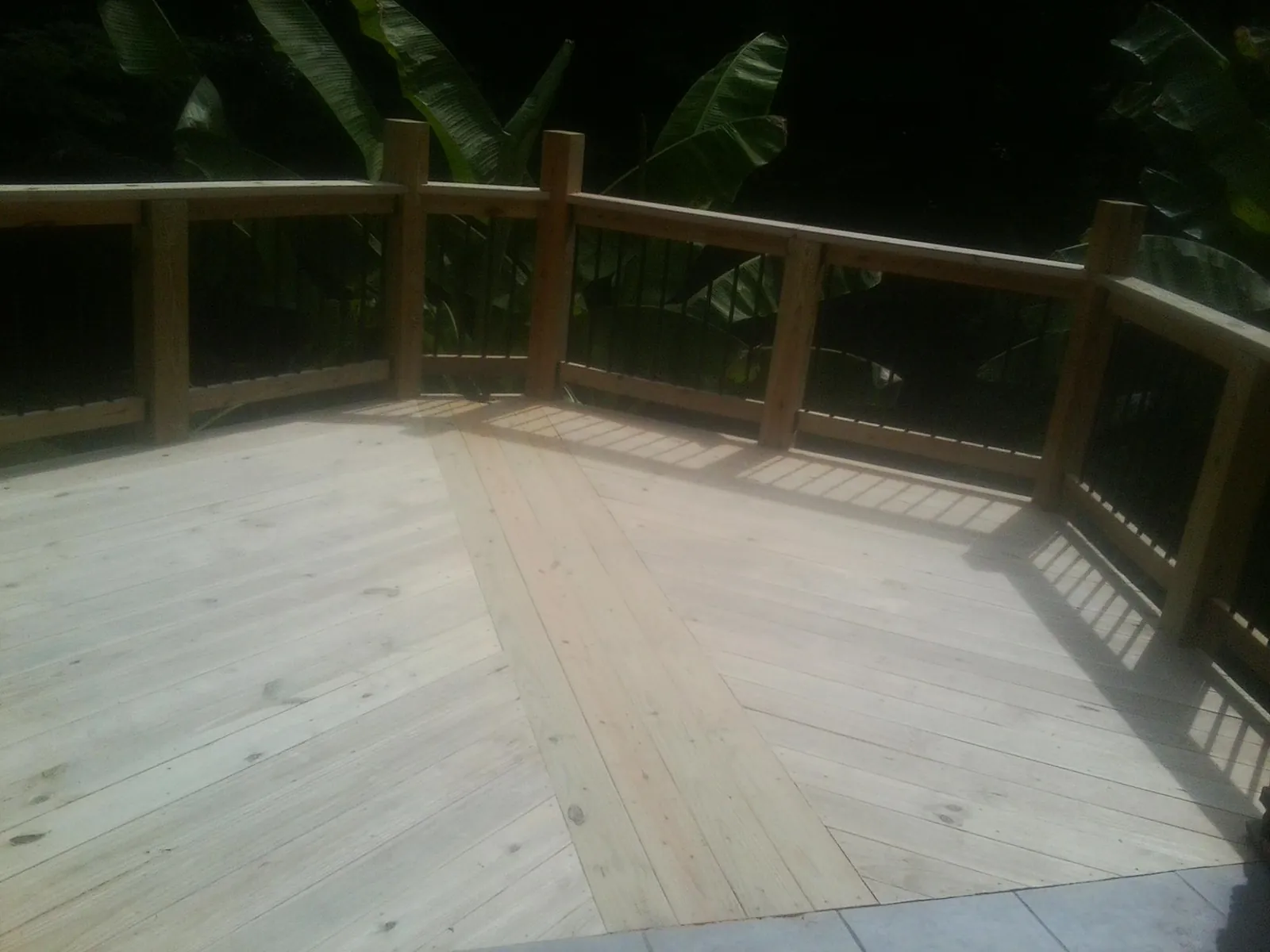 New wood deck and railing built off the back of a home in Commerce